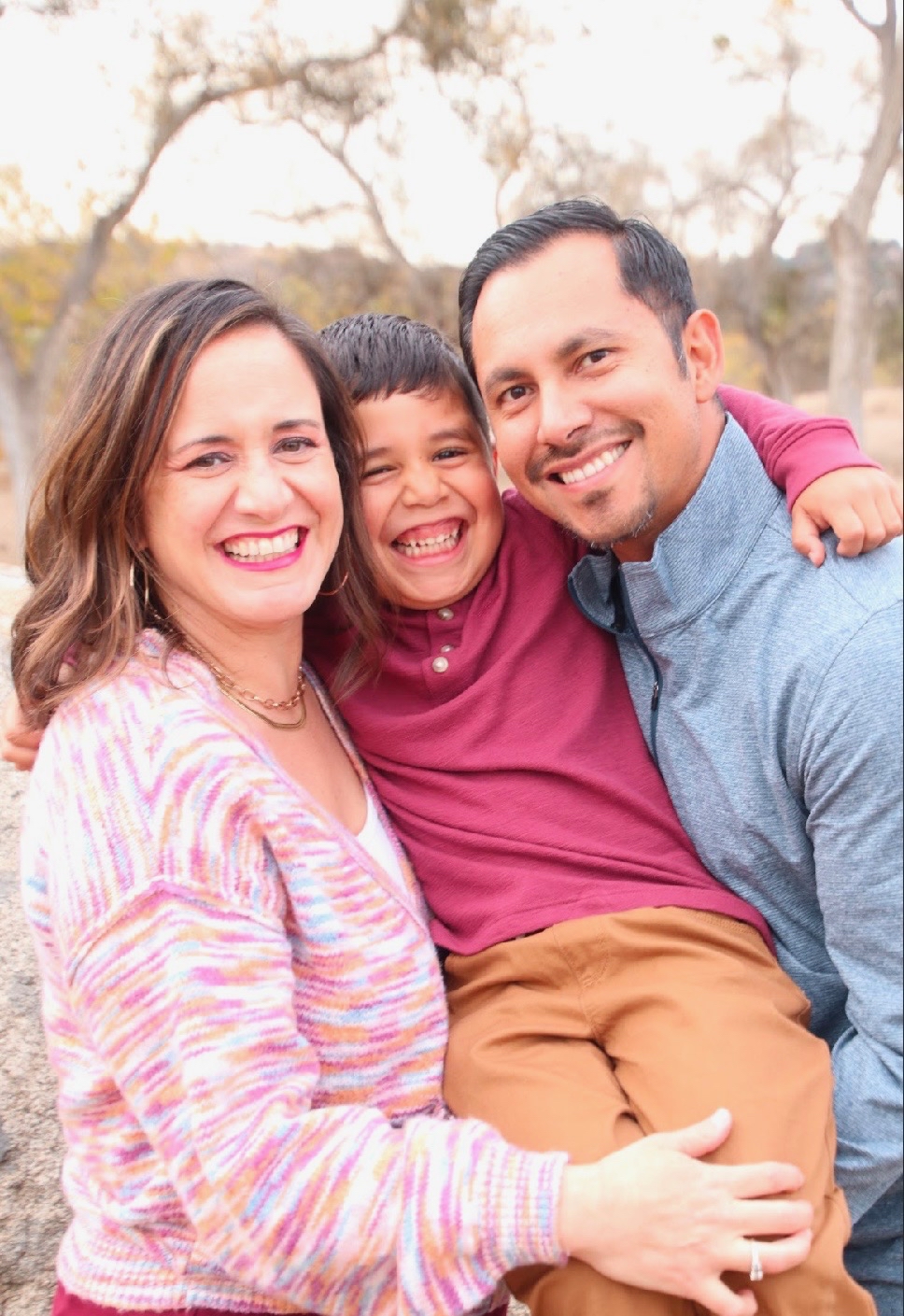 Nati, son, and husband smiling for photo