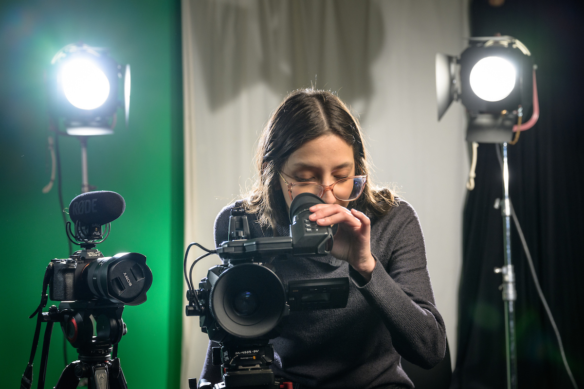 student behind camera