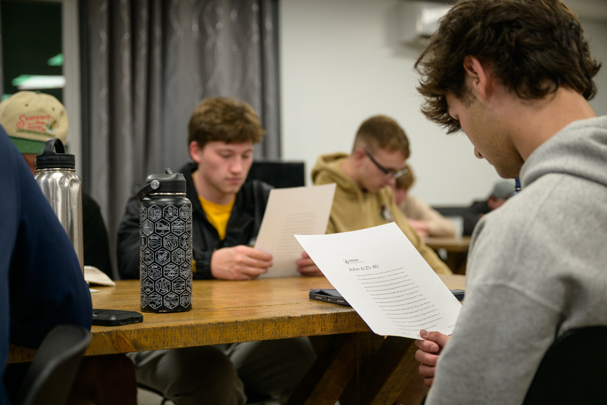 students reading Bible passage