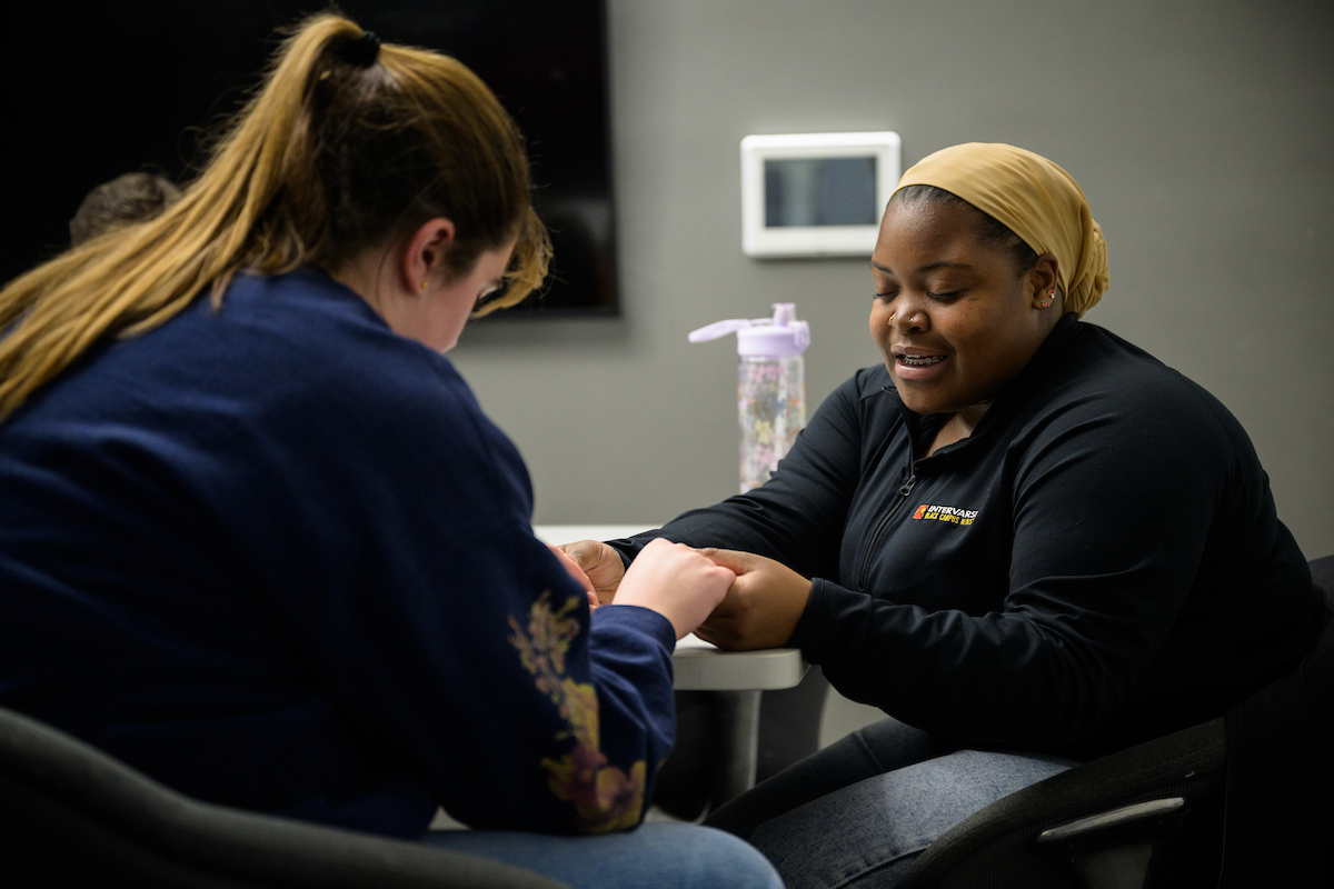 two student leaders praying