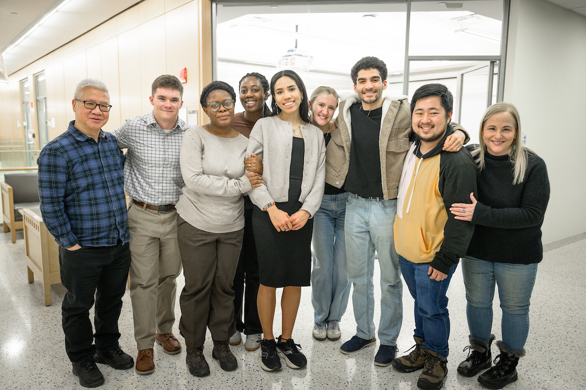 group of grad students pose for photo