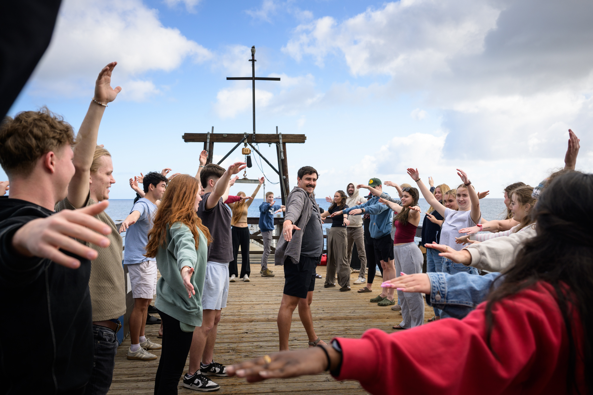 students crowd the dock early in the morning to stretch out their muscles by spelling out coconut