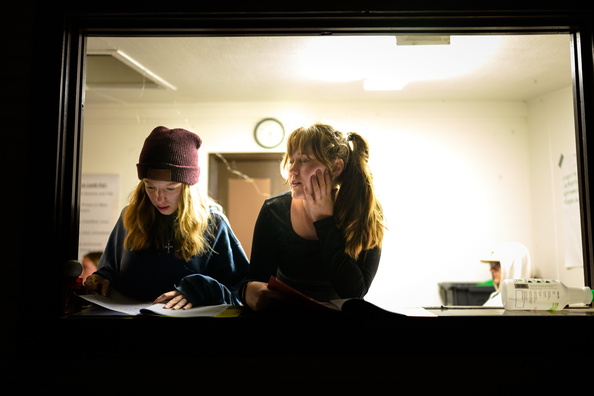 two female students reading and discussing what the passage means