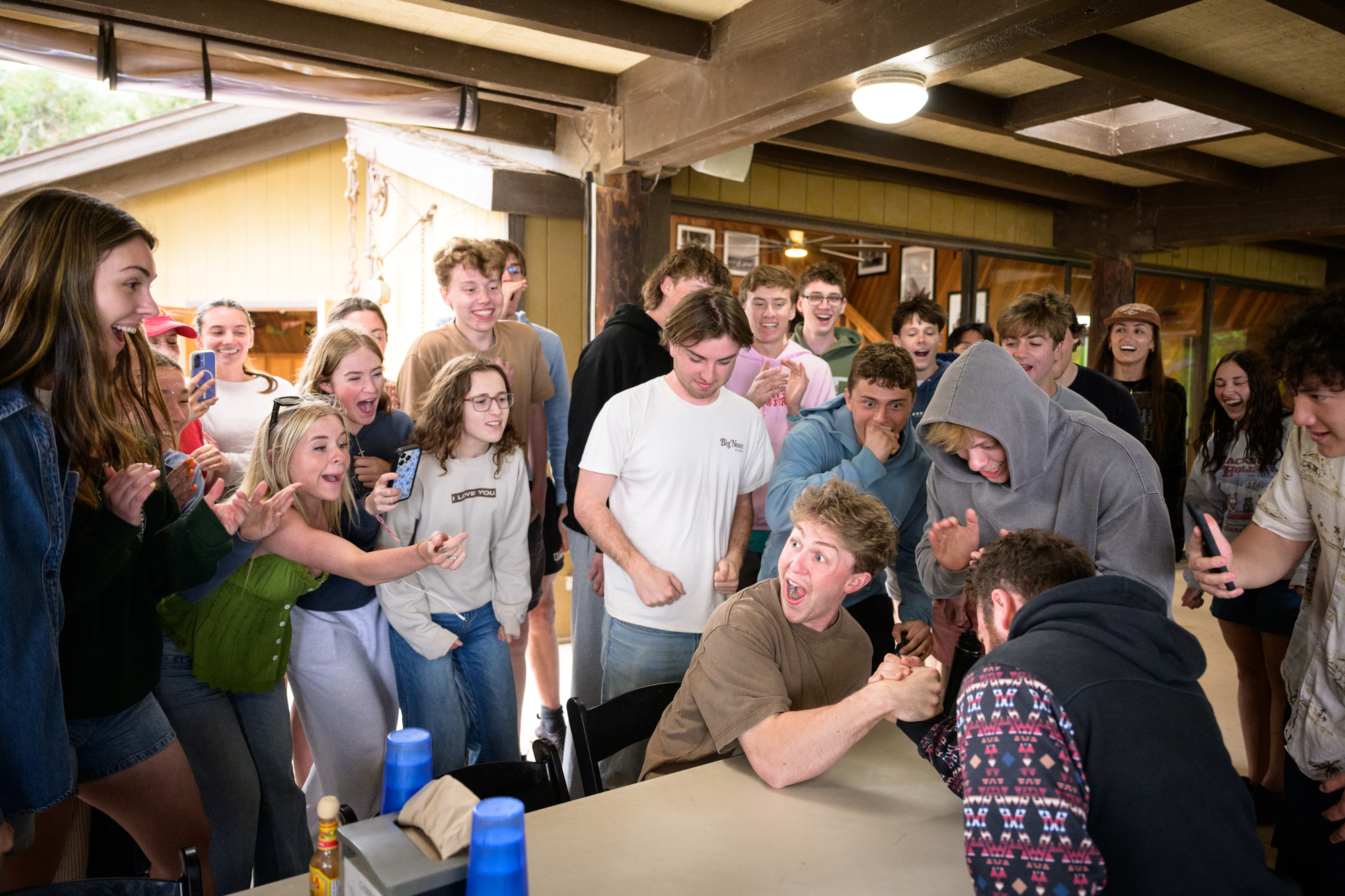 bringing to life the parable Jesus tells about a strong man (Mark 3:27) - two staff workers arm wrestle in front of their students to see who is the strongest as students cheer them on