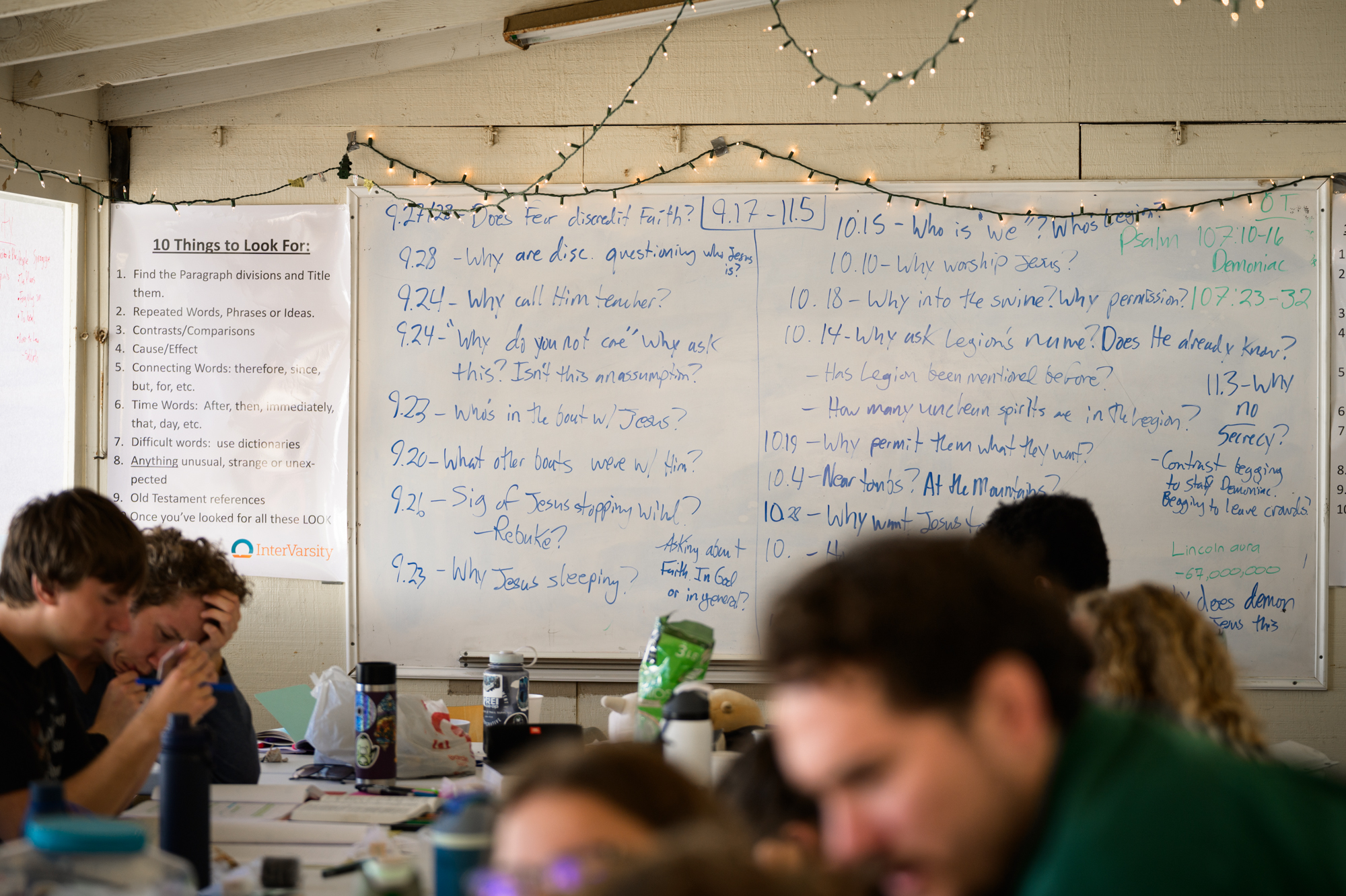 students in track time with questions about the book of Mark written on the white board.
