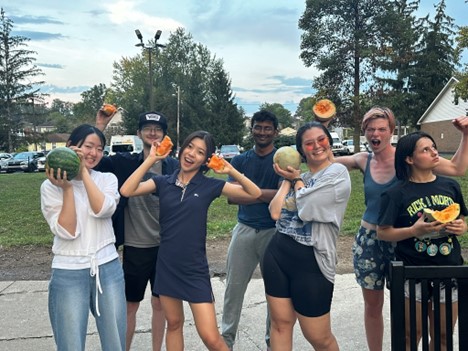 students posing with fruit for a silly photo