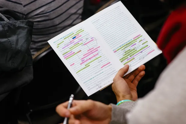 Person holding notebook and pen