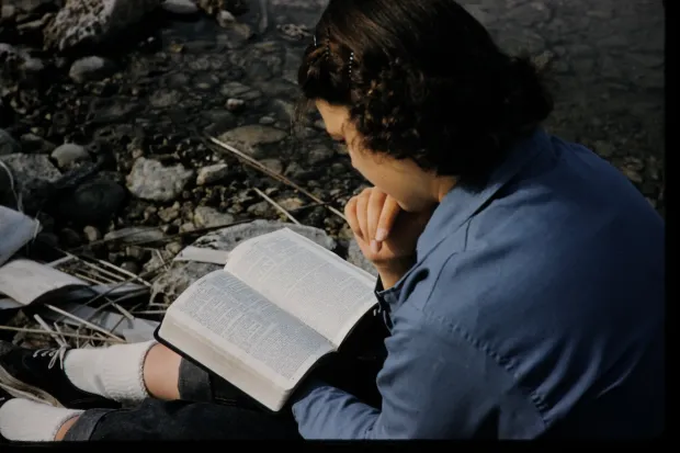 female student reading bible