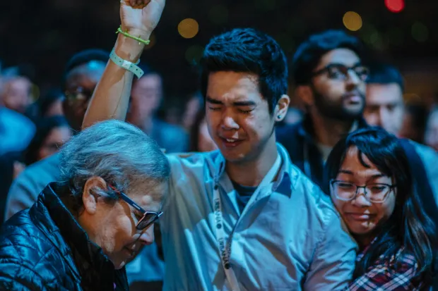 emotional hug between man making a faith decision and a woman friend