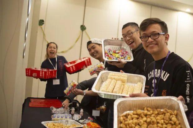Students at Native IV conference smiling and holding food 