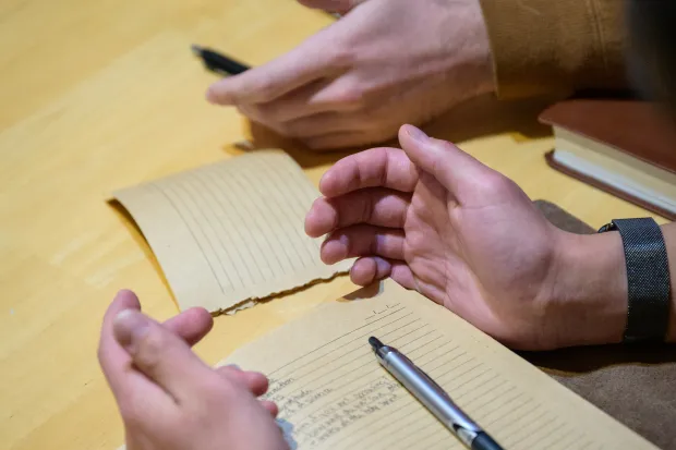 journal and open hands in prayer
