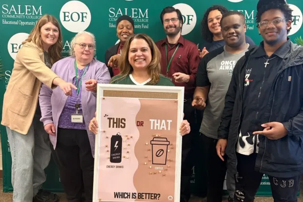 Group of students on campus with poster