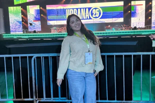 Angelica smiling in front of stage at Urbana 25
