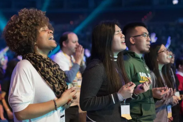 Diverse group of young men and women worshiping together