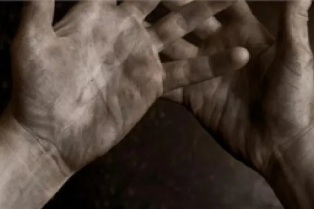 a close up of hands covered in ash and dirt