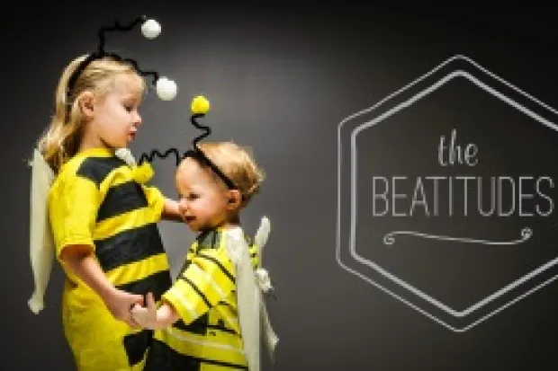 two small children dressed as bumblebees, and a graphic reading "The Beatitudes"