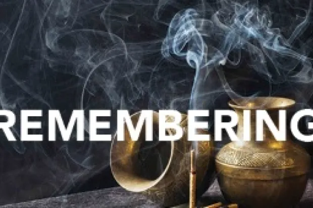 One urn turned on its side and one urn upright with stick of incense and the word "Remembering" across the image