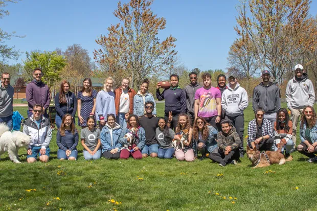 Group photo of students standing outside on lawn