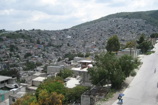 Panorama of a large city with thousands of houses filling a mountainside