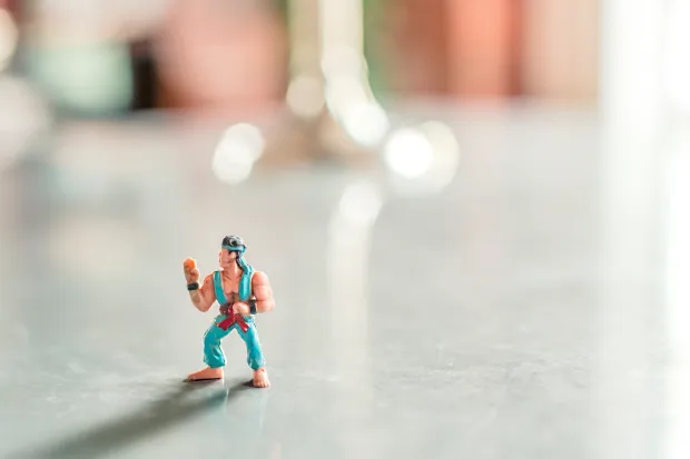 Small superhero action figure on the floor