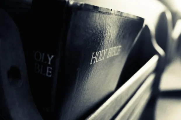 Leather bound Bible in pew rack close-up