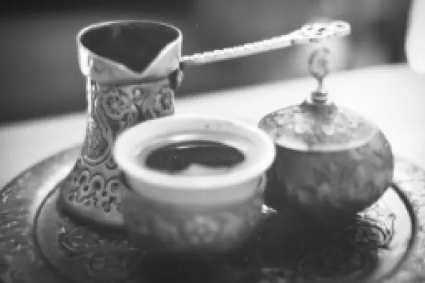 Black and white image of ornate coffee pot and cups