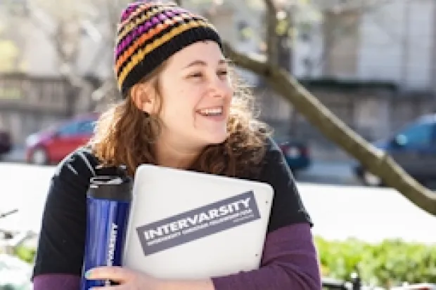 Female college student outside carrying school books