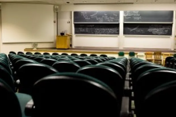 Empty classroom auditorium with stage and chalkboards