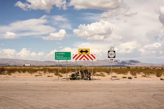 Dusty road dead end with several street signs