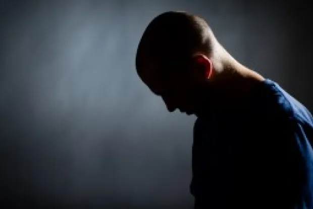 side view of a man with his head facing down