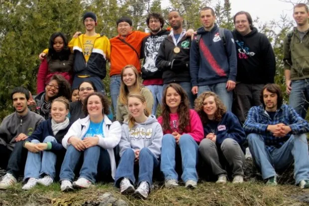 Group photo of UM-Flint chapter in forest