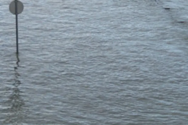 Flooded street with sign popping up out of water