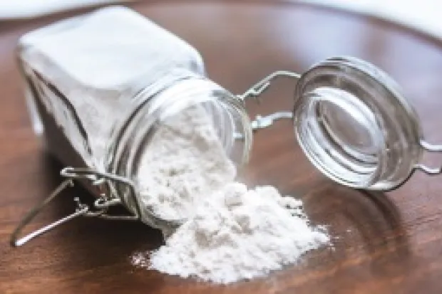 a flour jar tipped over on a table and spilling out