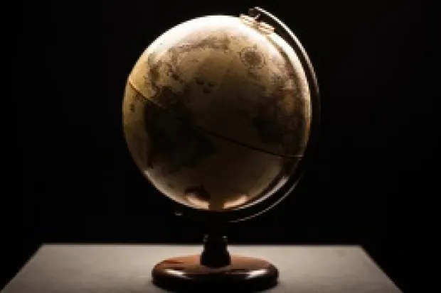 a globe sitting on a table in a dimly lit room