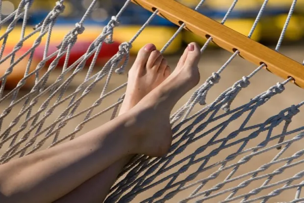 Closeup of person's feet propped up on hammock