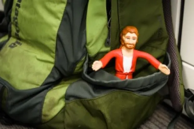 Jesus action figure stuck in backpack pocket