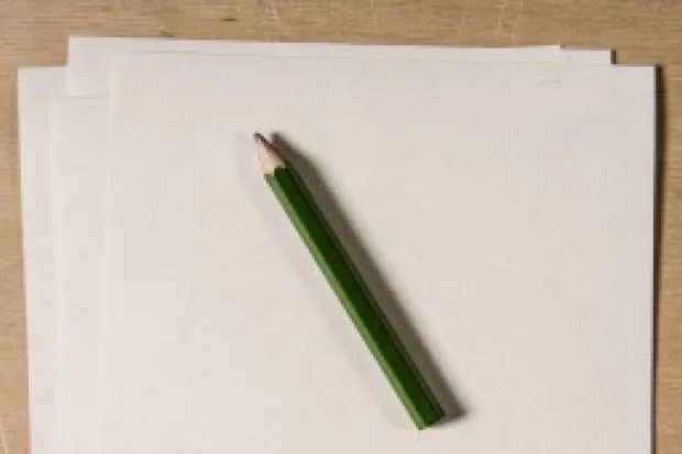 Blank pieces of paper with a pencil laying on top of them