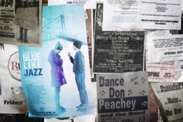 Clippings of newspapers beside Blue Like Jazz Movie Poster of young man holding umbrella for young woman