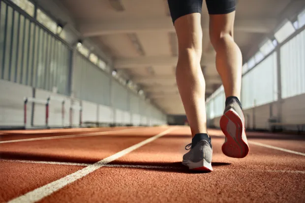 Closeup of runner's feet walking along indoor track