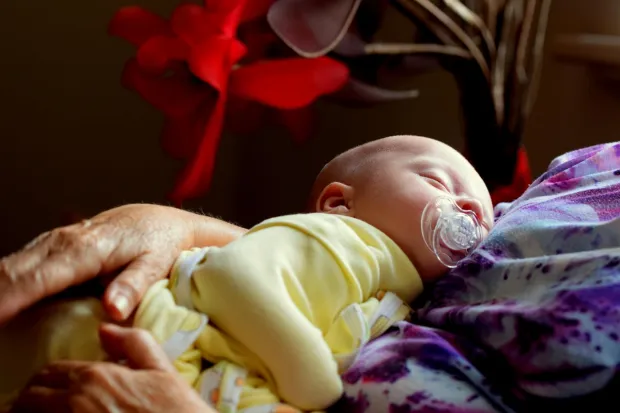 Baby resting in mother's arms