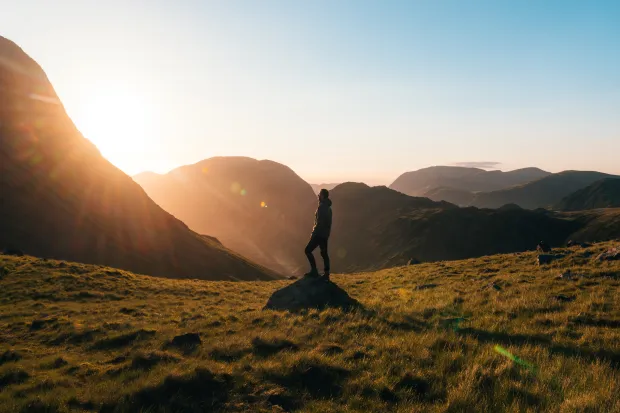 Person standing on rock in field