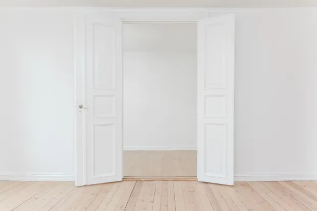 Empty rooms with plain white walls and open door