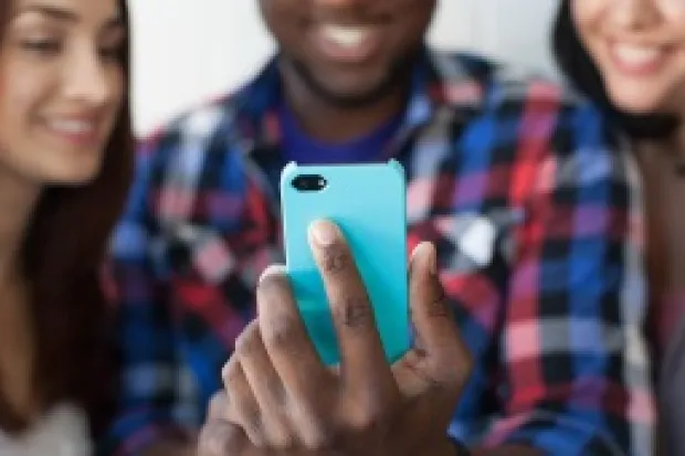 Group of three people posing for selfie