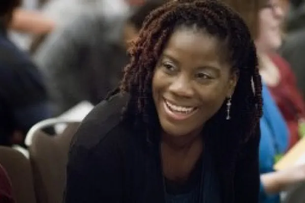 Closeup of woman smiling in conversation during conference