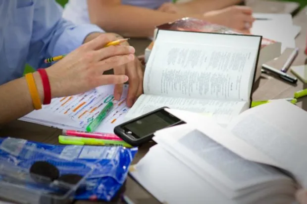 a Bible sitting open on a cluttered table