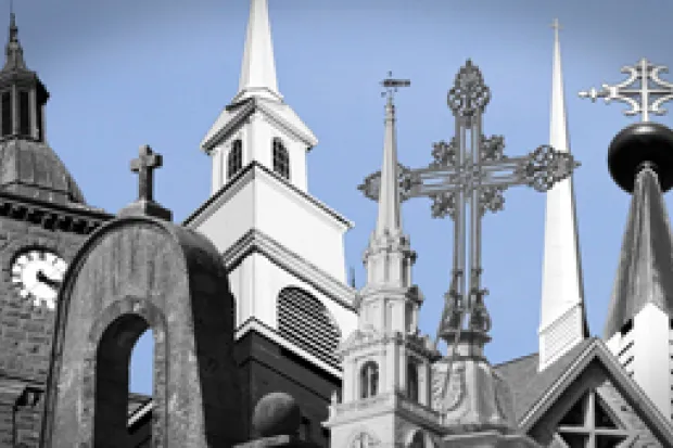 a skyline with a variety of steeples and cross-topped roofs