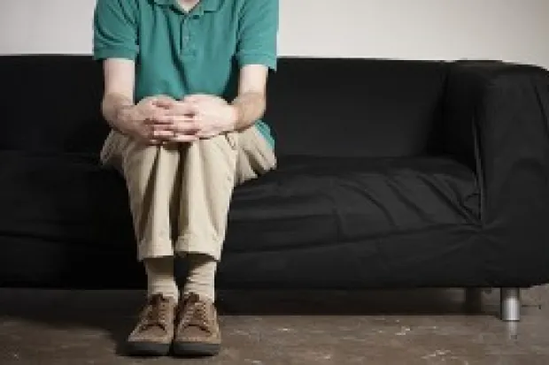 a man seated alone on a couch