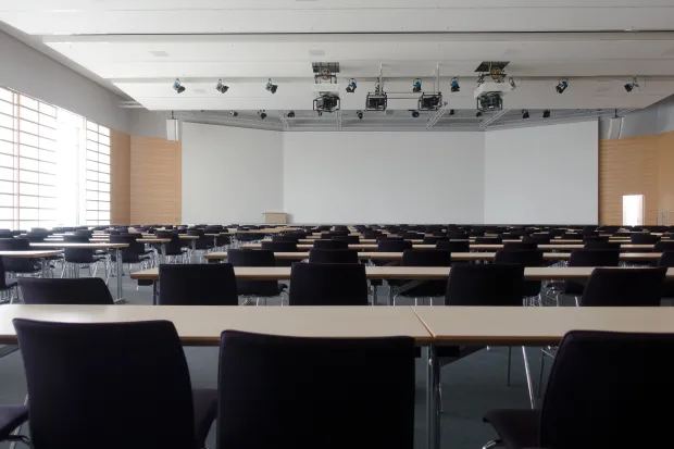 a whiteboard and chairs in an empty classroom