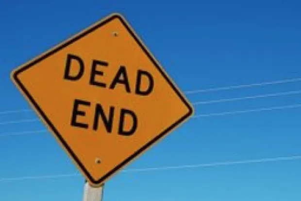 a yellow road sign reading "Dead End"