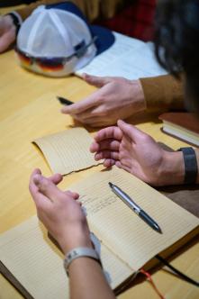 journal and open hands in prayer
